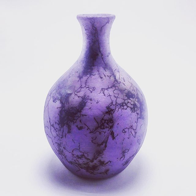 Purple vase with thin throat with black threadlike designs